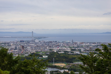 Fototapeta na wymiar Urban sprawl visible through trees at top of Ameyama, one of the popular lookout points in the area