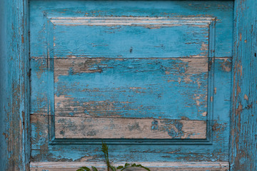 background as part of an old wooden door with peeling blue-gray paint
