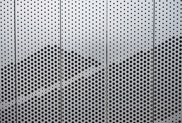 Wall of silver metal futuristic office building. Abstract architectural background