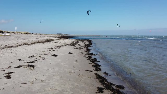 Kitesurfer on the beach on Fehmarn northern Germany. Gr&uuml;ner Brink Stock Footage