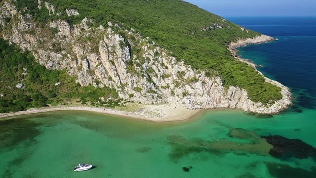 Aerial drone video of iconic secluded sandy beach with emerald sea in island of Sfaktiria next to bay and famous beach of Divari (chrysi akti), Messinia, Gialova, Peloponnese, Greece