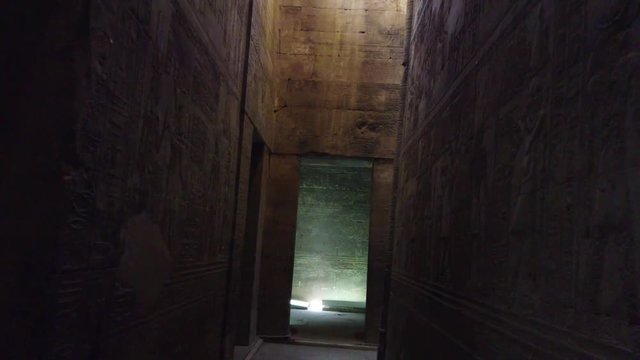 Walking through Ancient Egyptian ruins of Edfu Temple wall carvings