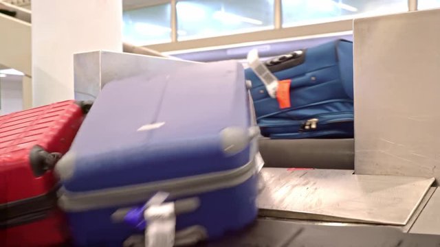 New York, United States, June 10, 2018: Luggage arriving on baggage carousel waiting for travelors at the depature hall of John F. Kennedy airport