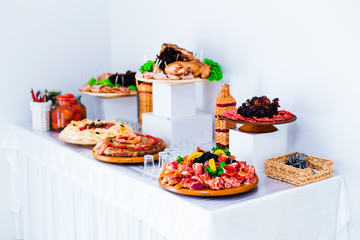 meat slices of beef, pork on wooden plates and drink. wedding re