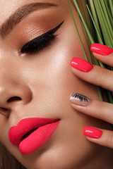 Naklejka premium Beautiful young woman with bright makeup and neon pink nails. Beauty face. Photo taken in the studio