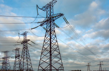  high-voltage  power lines at sunset.