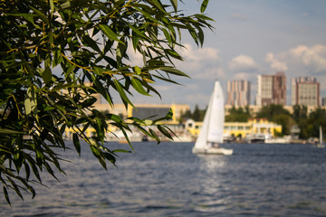  Moscow / Russia - July, 27, 2019: sailing boat with white sails on Khimki reservoir on a cloudy...