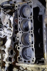 The cylinder block of the four-cylinder engine. Disassembled motor vehicle for repair. Parts in...