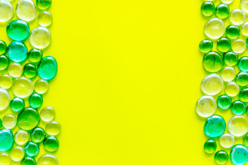 Bright stones frame on yellow background top view mock up