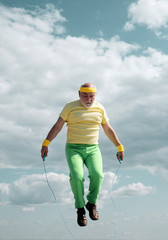 Senior man working out on a skipping rope. Senior sportsman in sport center. Healthy and sport....