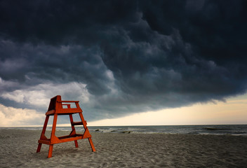 Orange lifeguard station under very stormy skies on the Atlantic Coast