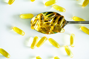 Vitamins supplements, fish oil in yellow capsules omega 3.