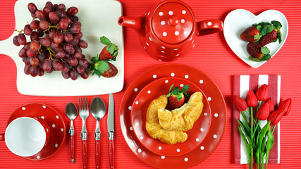 Modern bright colorful red theme morning breakfast or brunch table setting, flat lay.