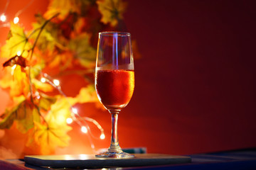Champagne glass on table against blurred lights background - perspective of crystal clear wine glass for night party on the counter top bar restaurant