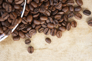 Coffee beans roasted on rustic wood