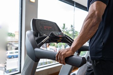 group of young people running on treadmills in modern sport gym