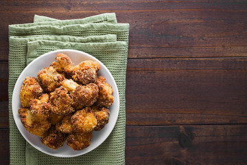 Fried breaded cauliflower florets on plate, copy space on the side (Selective Focus, Focus on the...