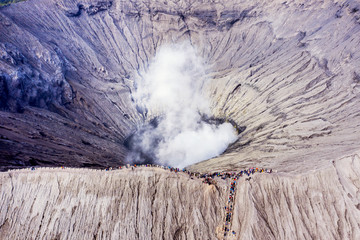 Crowded tourist hiking crater of Bromo volcano