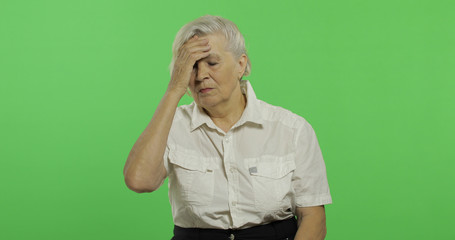 An elderly woman suffer by headache pain trouble. Old grandmother. Chroma key