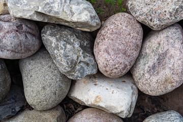 Many decorative colored stones are arranged in the background.