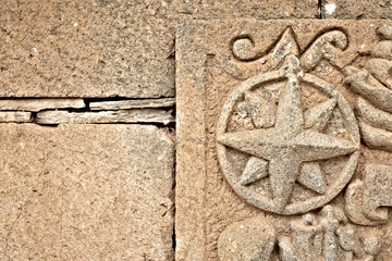 Windrose / compass rose relief image in sandstone.