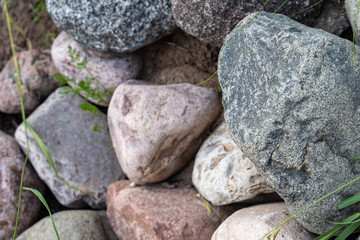 Many decorative colored stones are arranged in the background.