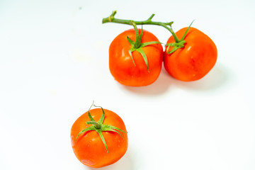 Fresh red tomato with green leaves isolated on white background Clipping Path. Full depth of field.