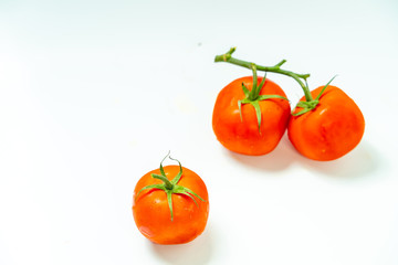 Fresh tomatoes isolated on white background.	