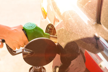 Car gas nozzle refuel fill up with petrol gasoline at a gas station. Close up.