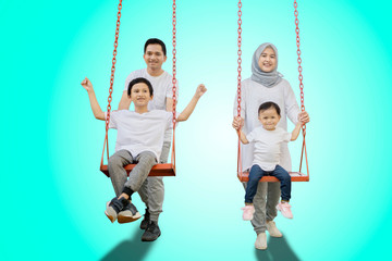 Parents and children playing with swings