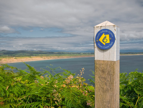 Wooden sign post on the Wales Coast Path on the Llyn Peninsula, Gwynedd, Wales, UK
