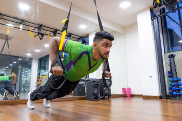 Cheerful young athlete doing exercise