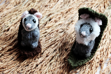Fototapeta premium Cute mouse relax on sheaf of paddy, woolen small rat