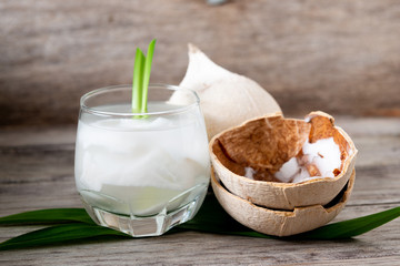 Fresh coconut juice in a glass with coconut white meat isolated on white