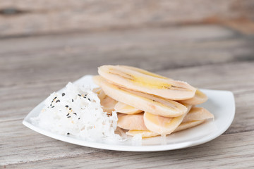Boiled slice banana eat with coconut
