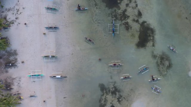 Drone shot of the beautiful Paradise Beach coastline in Bantayan Philippines with Baroto boats on the shore