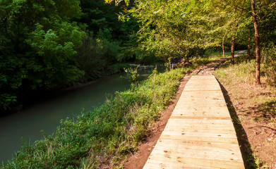 A wooden walkway along Nine Mile Run in Frick Park in Pittsburgh, Pennsylvania, USA