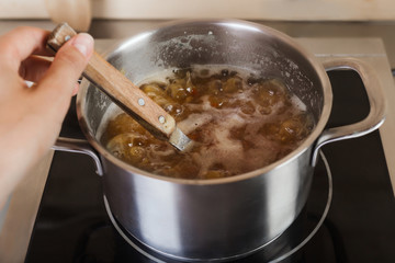 Boiling soup in pan on electric stove in the kitchen