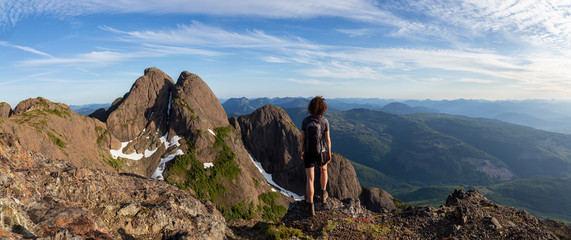 Adventurous girl hiking the beautiful trail in the Canadian Mountain Landscape during a vibrant...