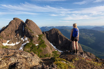 Adventurous girl hiking the beautiful trail in the Canadian Mountain Landscape during a vibrant summer evening. Taken at Mt Arrowsmith, near Nanaimo, Vancouver Island, BC, Canada.