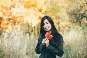 Female beauty portrait surrounded by vivid foliage. Dreamy beautiful girl with long natural black...