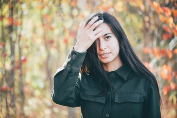 Female beauty portrait surrounded by vivid foliage. Dreamy beautiful girl with long natural black...