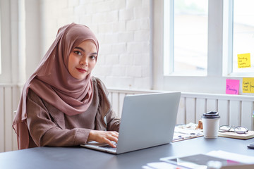 Happy professional arab businesswoman brown hijab working at home.