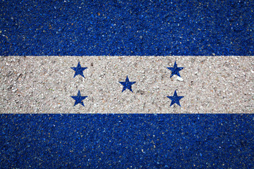 National flag of Honduras on a stone background.The concept of national pride and symbol of the...
