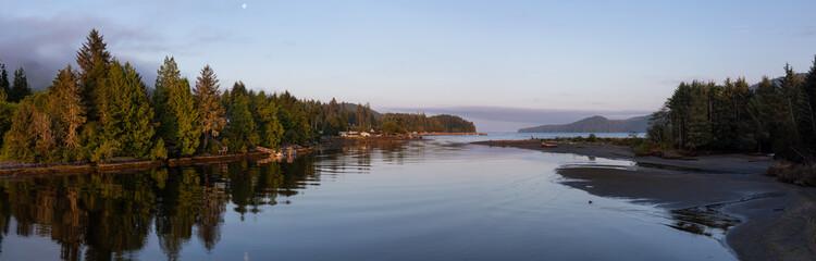 Fototapeta na wymiar Beautiful Panoramic View of a river joining the ocean in a small town during a cloudy and sunny summer sunrise. Taken at Port Renfrew, Vancouver Island, BC, Canada.