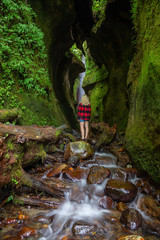 View of a river and a waterfall in a beautiful natural canyon. Taken in Sombrio Beach near Port Renfrew, Vancouver Island, BC, Canada.