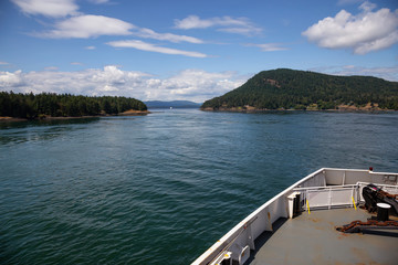 Fototapeta na wymiar Beautiful View of a Ferry Boat passing in the Gulf Islands Narrows during a sunny summer day. Taken near Vancouver Island, British Columbia, Canada.