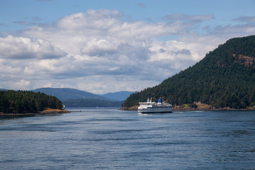 Fototapeta na wymiar Beautiful View of a Ferry Boat passing in the Gulf Islands Narrows during a sunny summer day. Taken near Vancouver Island, British Columbia, Canada.