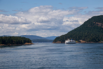 Beautiful View of a Ferry Boat passing in the Gulf Islands Narrows during a sunny summer day. Taken near Vancouver Island, British Columbia, Canada.