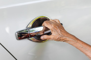 Elderly woman open the car door